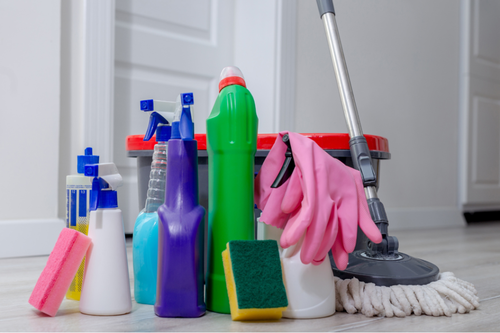 Assorted cleaning supplies and a mop bucket in a tidy home setting, representing affordable house cleaning in York, PA.